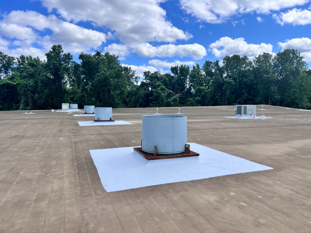 Waterproofed flat roof area around rooftop HVAC unit