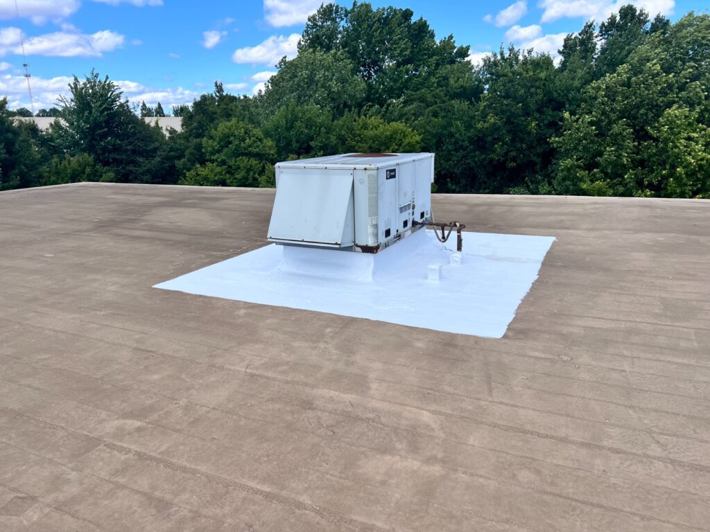 Flat roof coating applied around commercial roof vent
