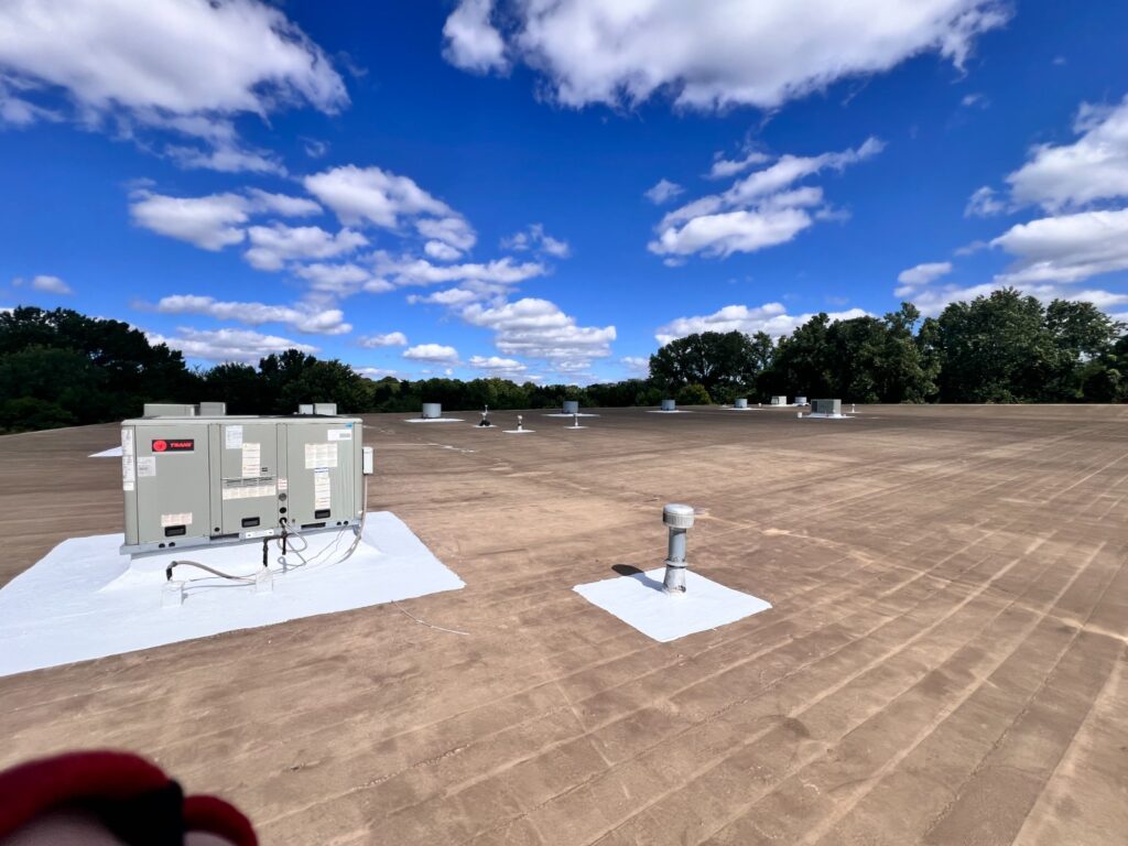 Completed flat roof repairs around rooftop units and vents