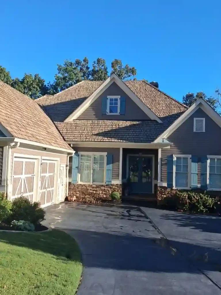 Restored cedar shake roof over garage in Dawsonville GA after soft wash and oil treatment Dawsonville GA